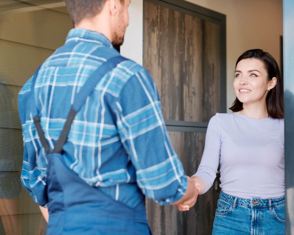 happy-young-client-of-maintenance-service-shaking-hand-of-technician.jpg